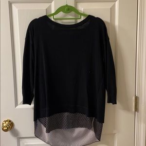Black sweater with polka dot under layer